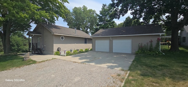 view of front of property with a garage and a front lawn