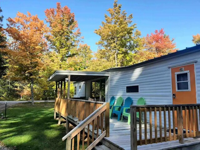 wooden deck featuring a yard