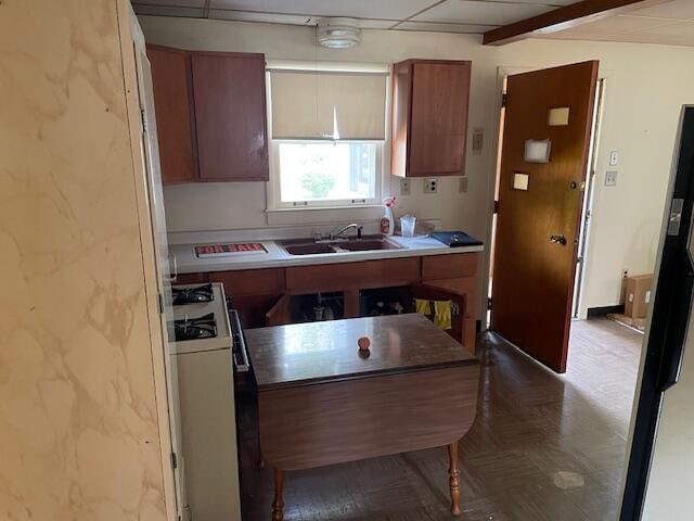 kitchen with sink and white range