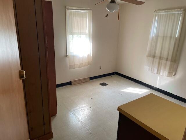 empty room featuring light tile patterned floors and ceiling fan