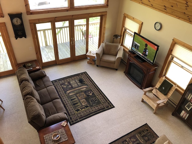 living room featuring a high ceiling and carpet flooring