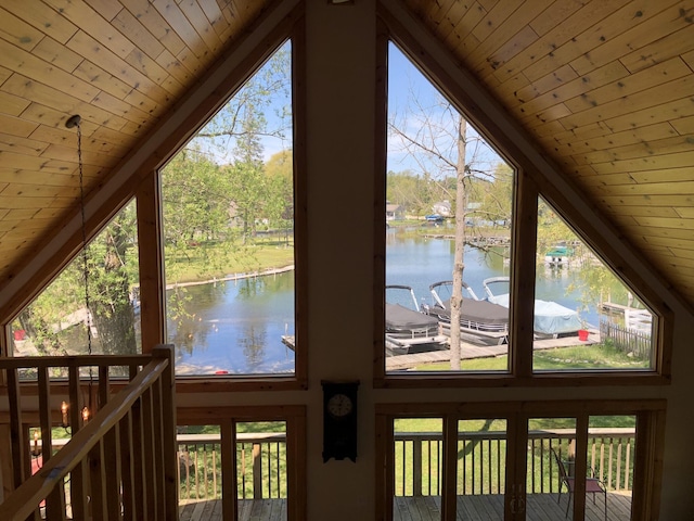 doorway featuring vaulted ceiling, a water view, a wealth of natural light, and wooden ceiling