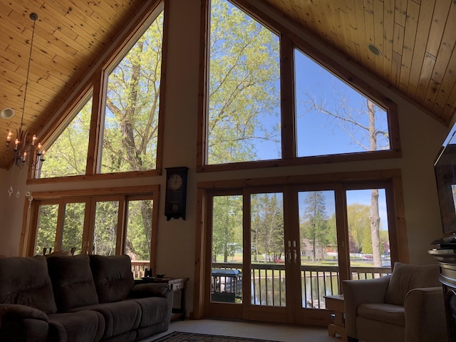 living room with high vaulted ceiling, wood ceiling, and french doors