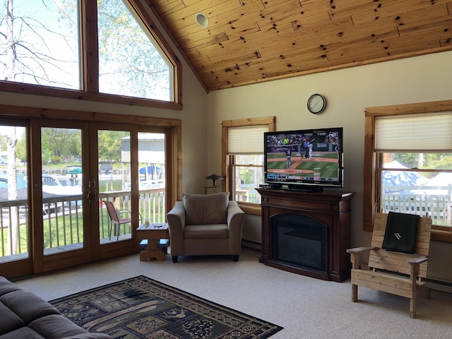 carpeted living room featuring high vaulted ceiling, wooden ceiling, and french doors