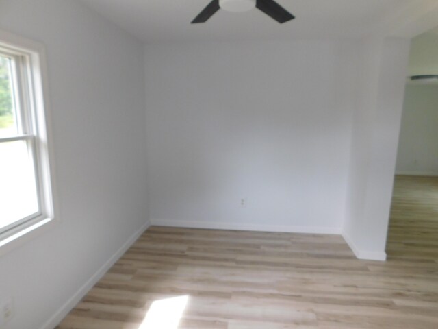 spare room with light hardwood / wood-style floors and ceiling fan