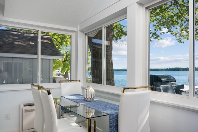 sunroom featuring a water view and plenty of natural light