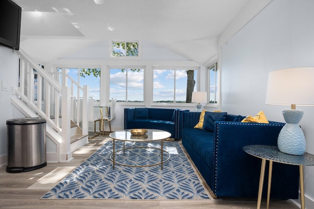 living room featuring hardwood / wood-style floors and lofted ceiling