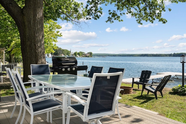 wooden deck featuring grilling area and a water view