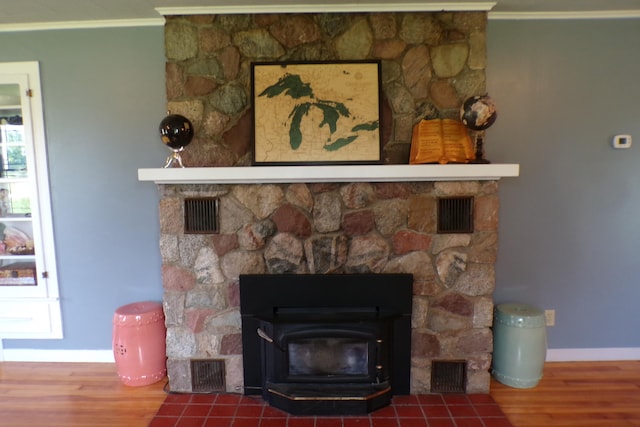 details featuring wood-type flooring, a wood stove, and ornamental molding