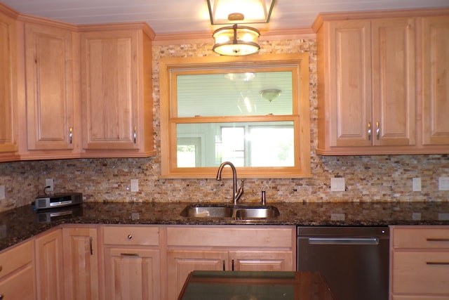 kitchen featuring dark stone countertops, dishwasher, sink, and light brown cabinets