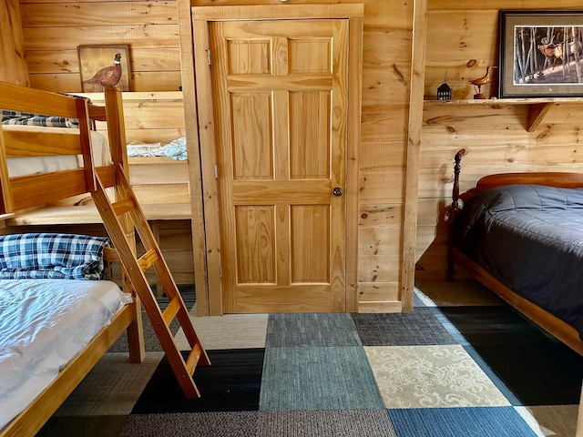 bedroom featuring wooden walls