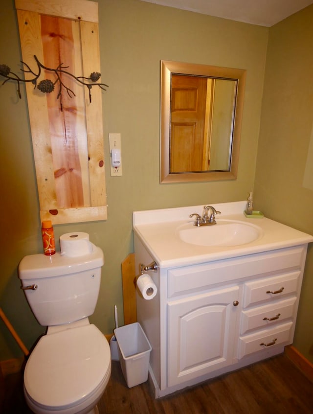 bathroom with vanity, hardwood / wood-style flooring, and toilet