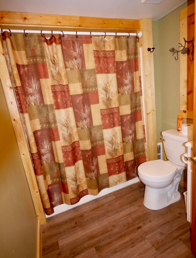 bathroom with toilet and hardwood / wood-style floors