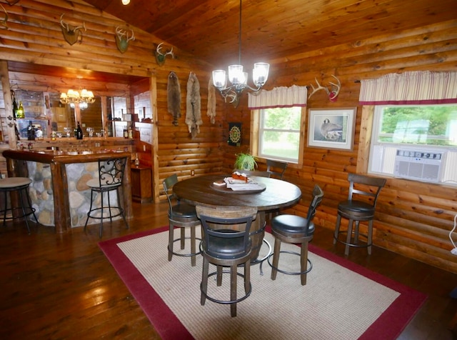 dining room featuring a notable chandelier, dark hardwood / wood-style flooring, and rustic walls