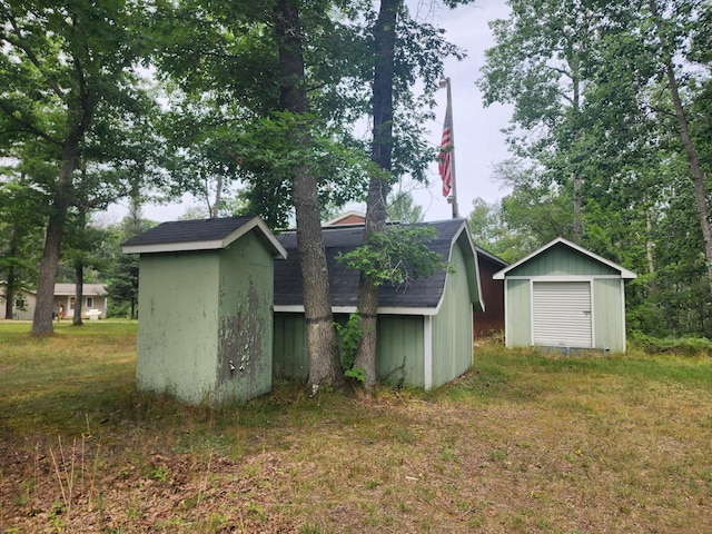 back of property featuring a shed and a yard