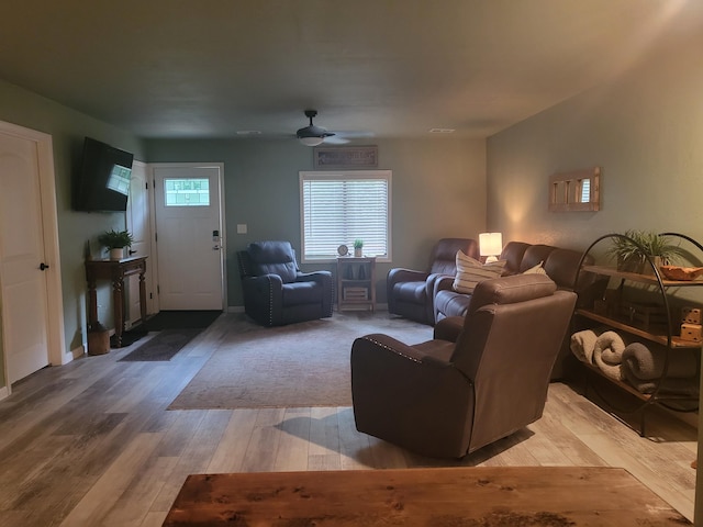 living room with hardwood / wood-style floors and ceiling fan