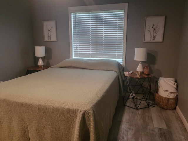 bedroom with hardwood / wood-style floors