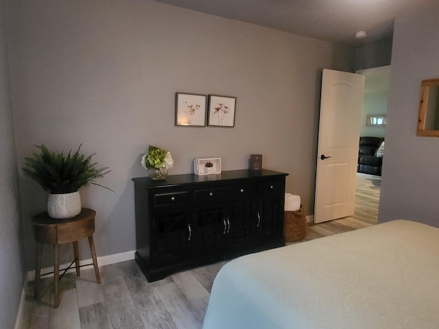 bedroom with hardwood / wood-style flooring