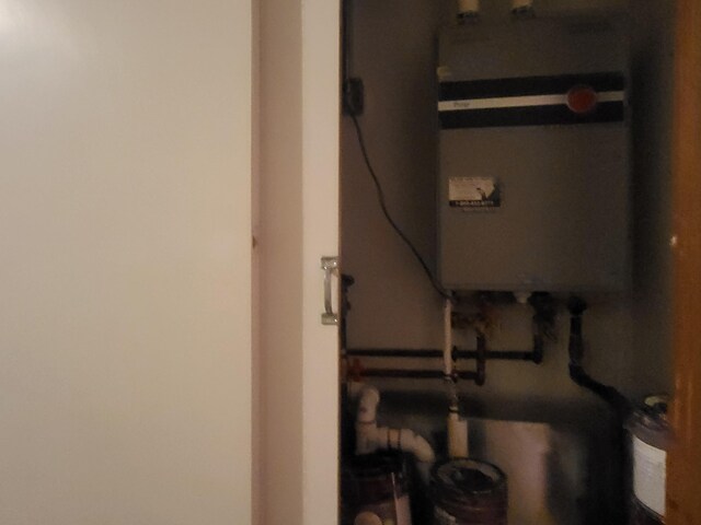 utility room featuring water heater