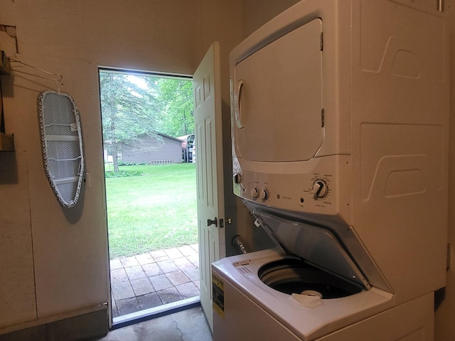 washroom with stacked washer and dryer and a wealth of natural light