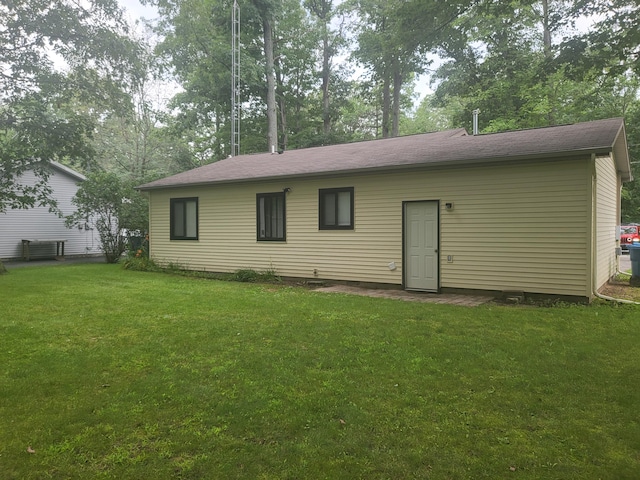 rear view of property with a lawn