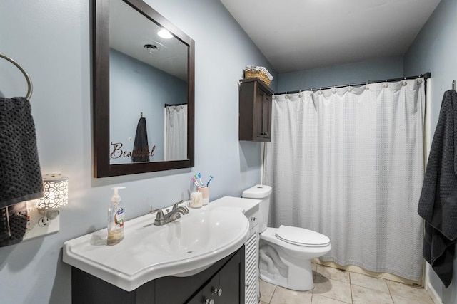 full bathroom featuring curtained shower, vanity, toilet, and tile patterned floors