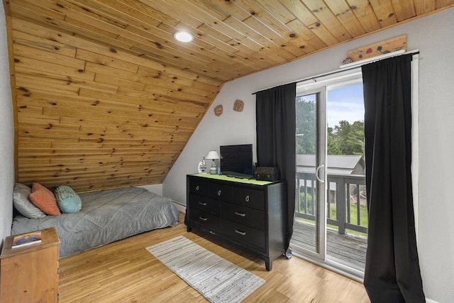 bedroom featuring multiple windows, light wood-type flooring, wood ceiling, and access to exterior