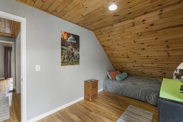 bedroom with wood ceiling, baseboards, vaulted ceiling, and wood finished floors