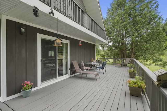 deck with outdoor dining area