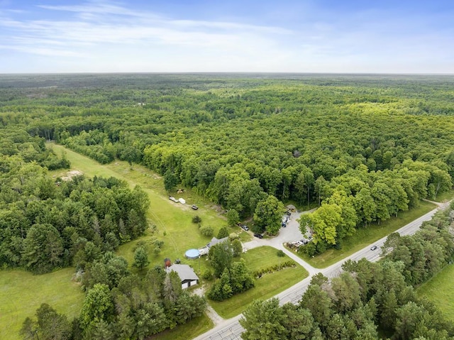 drone / aerial view featuring a view of trees