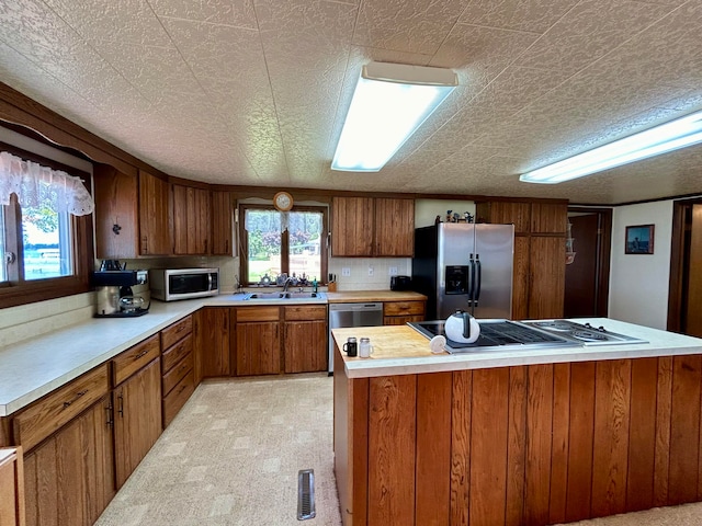 kitchen featuring sink, appliances with stainless steel finishes, and light colored carpet