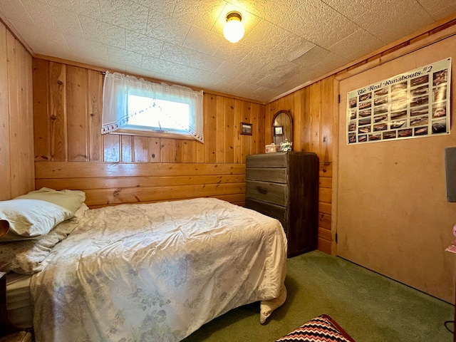 carpeted bedroom featuring wooden walls