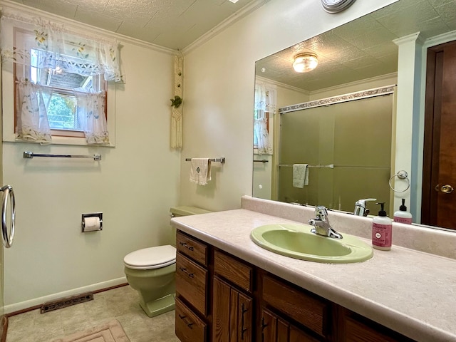 bathroom with vanity, toilet, tile patterned floors, and crown molding