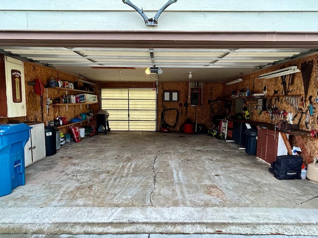 garage with a workshop area and a garage door opener