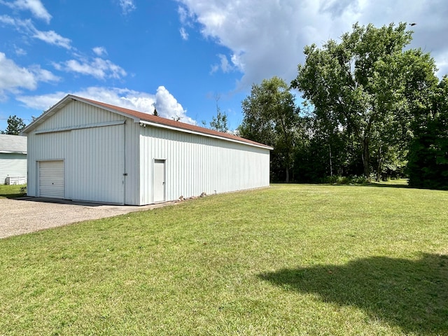 exterior space with a garage and an outbuilding