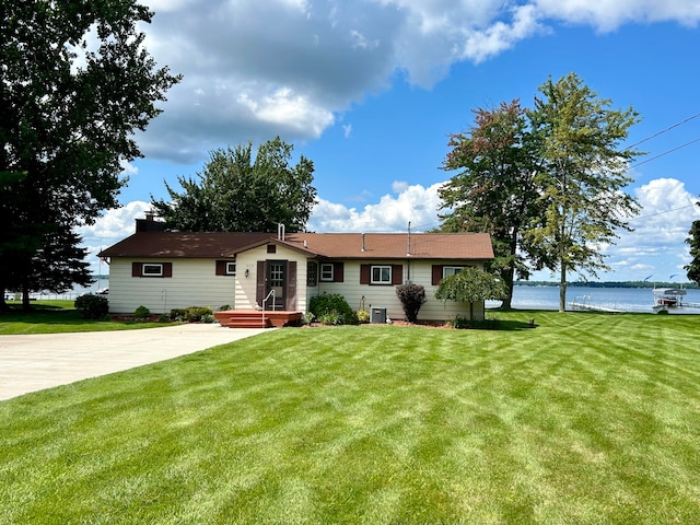 ranch-style home featuring a water view, central AC, and a front yard