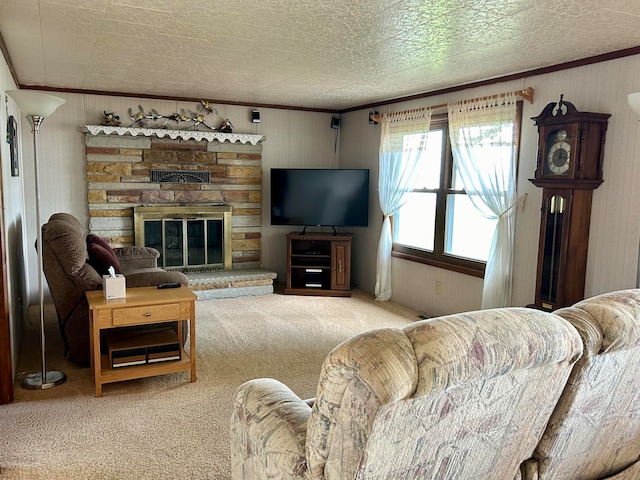 carpeted living room featuring a fireplace, a textured ceiling, and crown molding