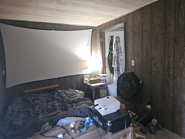 bedroom with a closet, wooden walls, and wood ceiling