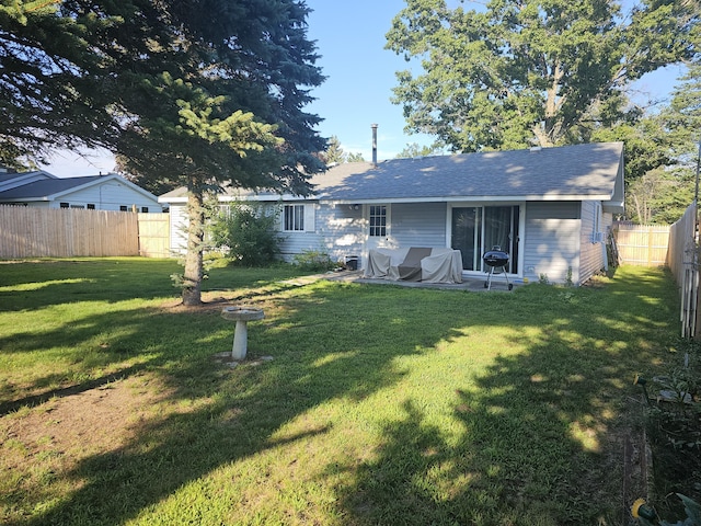 back of house featuring a lawn and a patio