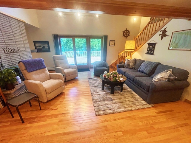 living area featuring stairs and light wood-type flooring