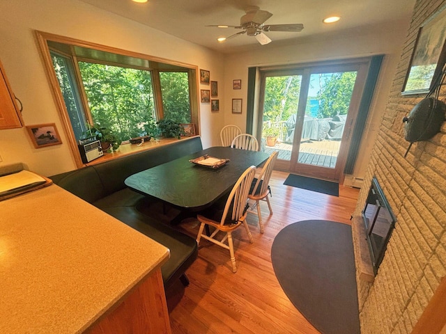 dining room featuring a ceiling fan, recessed lighting, baseboard heating, and light wood finished floors