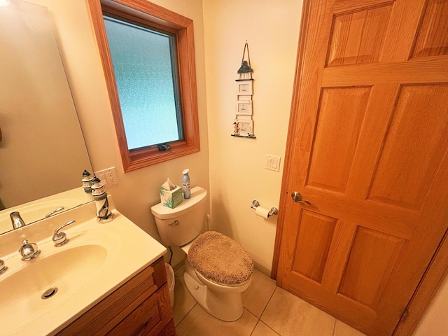 half bath featuring toilet, tile patterned floors, and vanity