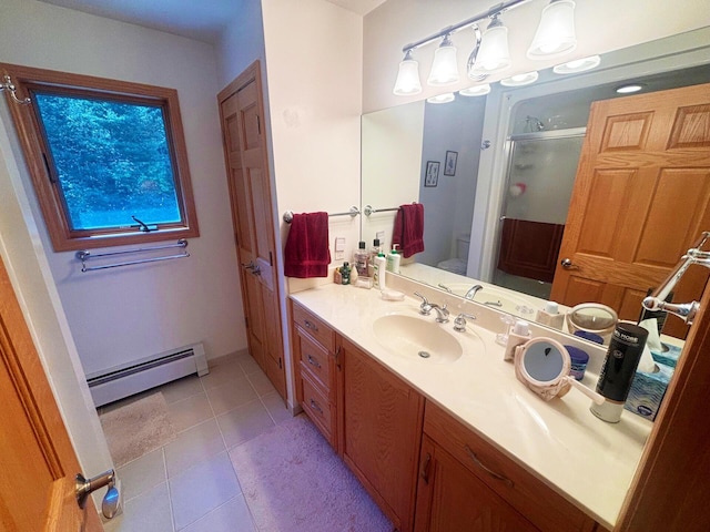 full bathroom with toilet, a baseboard heating unit, a stall shower, vanity, and tile patterned floors