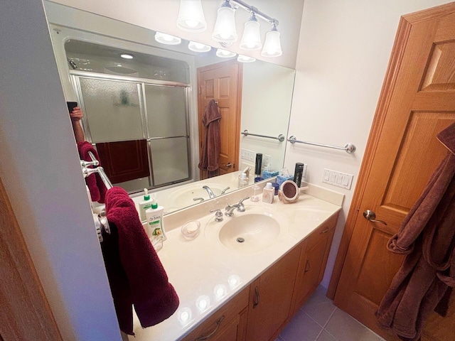 bathroom with tile patterned flooring, vanity, and an enclosed shower