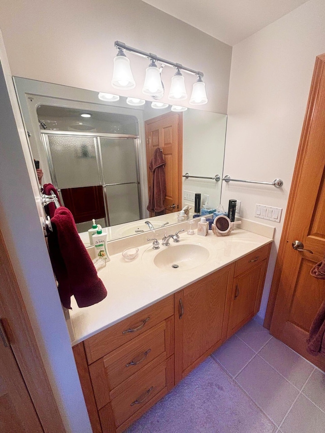 bathroom featuring a stall shower, vanity, and tile patterned floors