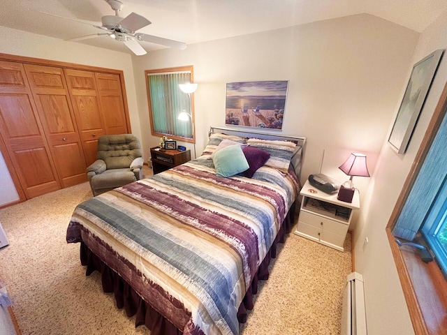 carpeted bedroom featuring a closet, a baseboard heating unit, and a ceiling fan