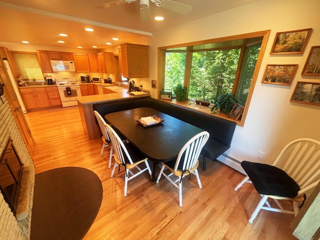 dining space featuring light wood-style floors, recessed lighting, ceiling fan, and a baseboard radiator