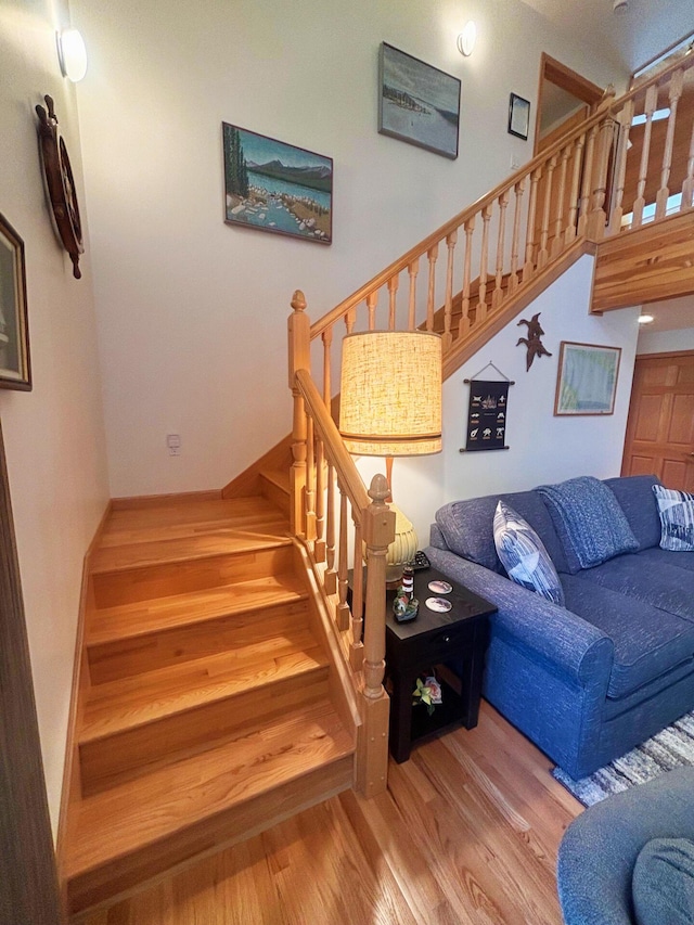 stairs featuring wood finished floors