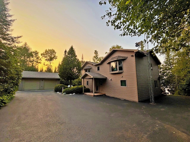 view of front of home with a garage and an outdoor structure