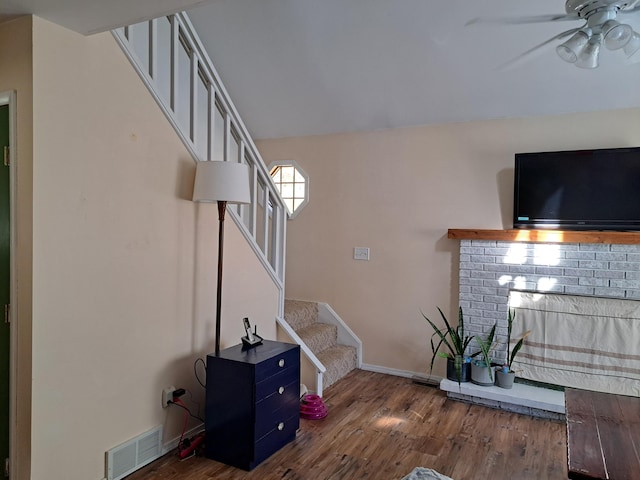 unfurnished living room featuring dark hardwood / wood-style floors and ceiling fan